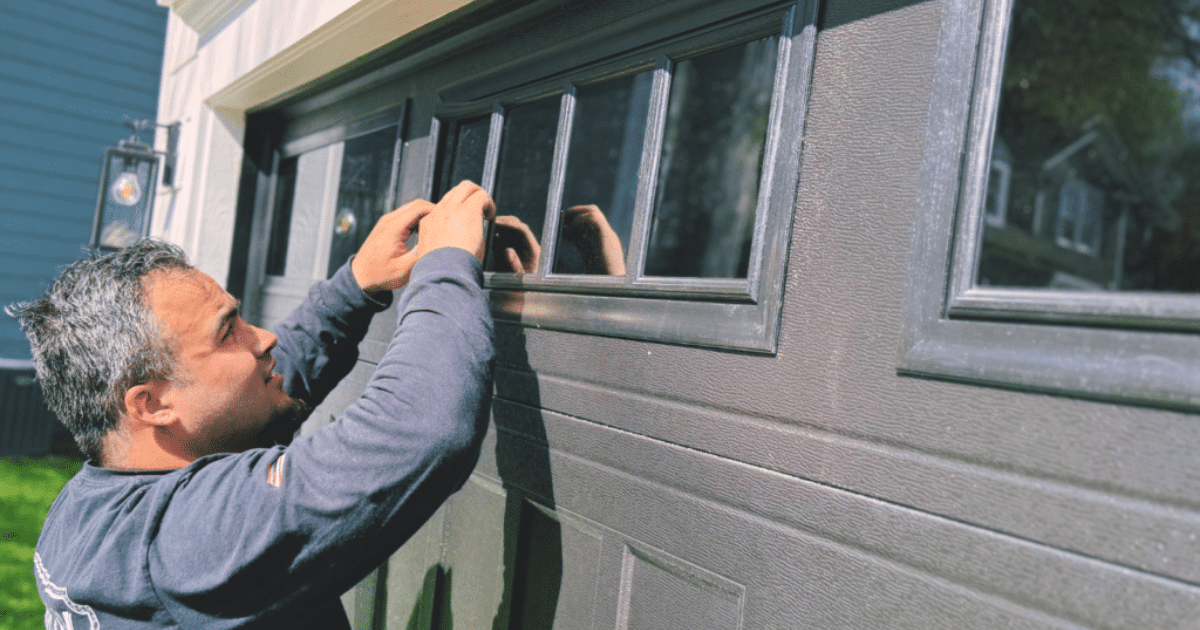 Technician repairing a garage door window.