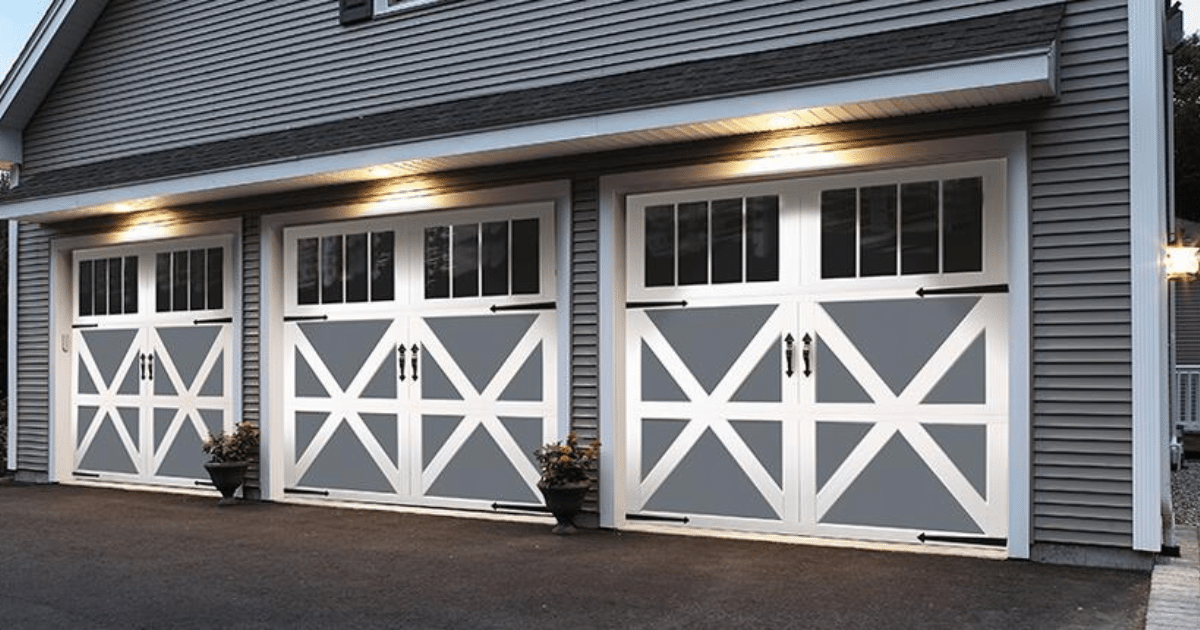 Three carriage-style garage doors lit up.