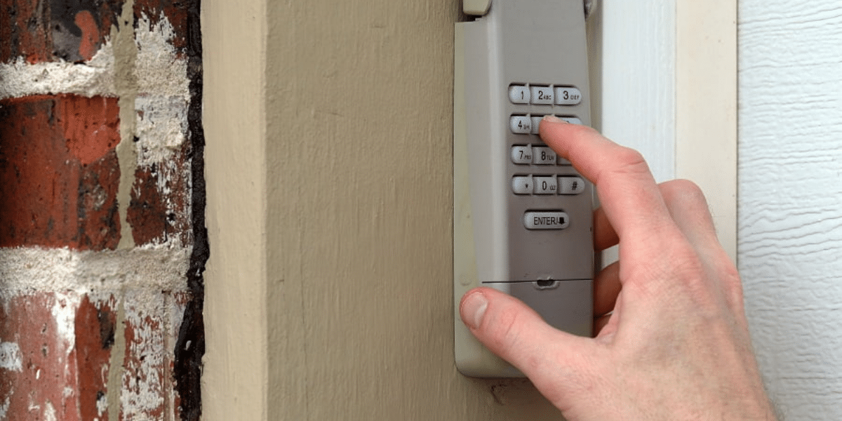 Person entering code on garage keypad.